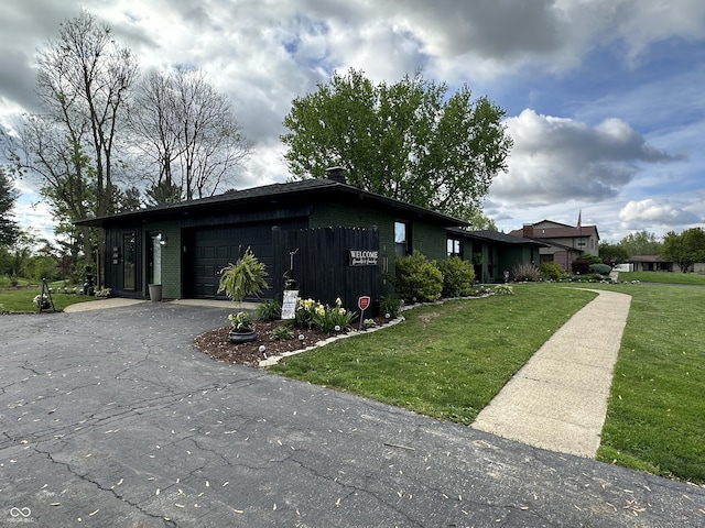 2028 Fairway Dr, Greencastle, IN 46135 - view of property exterior with an attached garage, a lawn, driveway, and brick siding