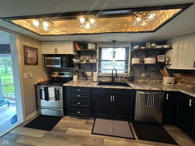 2028 Fairway Dr, Greencastle, IN 46135 - kitchen with stainless steel appliances, open shelves, a sink, tasteful backsplash, and dark cabinetry