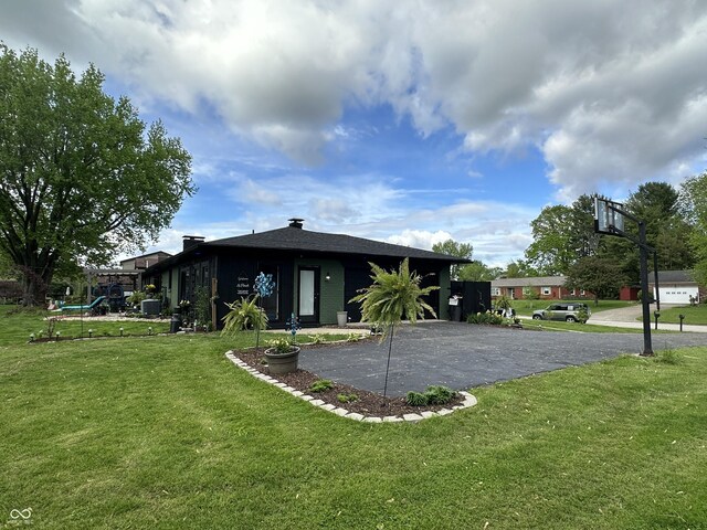 2028 Fairway Dr, Greencastle, IN 46135 - back of house with a yard, a garage, and asphalt driveway