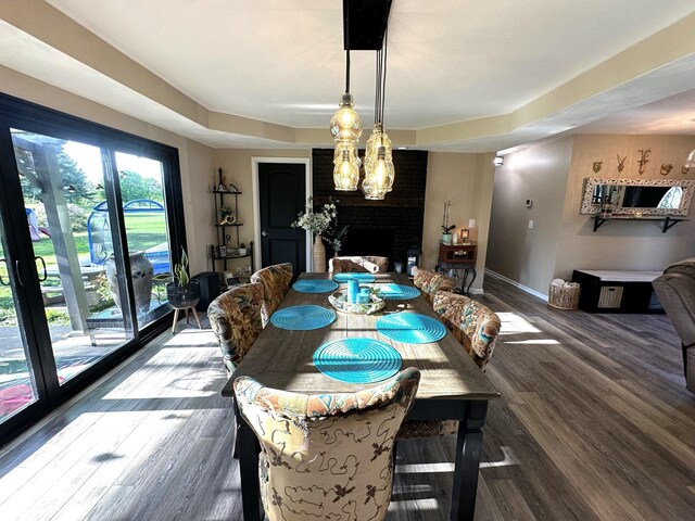 2028 Fairway Dr, Greencastle, IN 46135 - dining area with a large fireplace, wood finished floors, and baseboards