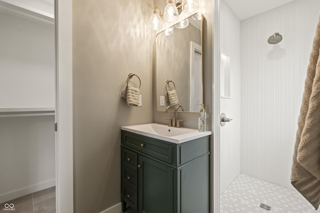 3526 Westfield Dr, Anderson, IN 46011 - bathroom featuring a shower stall, vanity, baseboards, and a chandelier