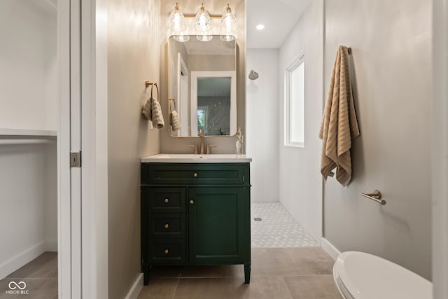 3526 Westfield Dr, Anderson, IN 46011 - full bathroom with tiled shower, vanity, toilet, tile patterned flooring, and baseboards