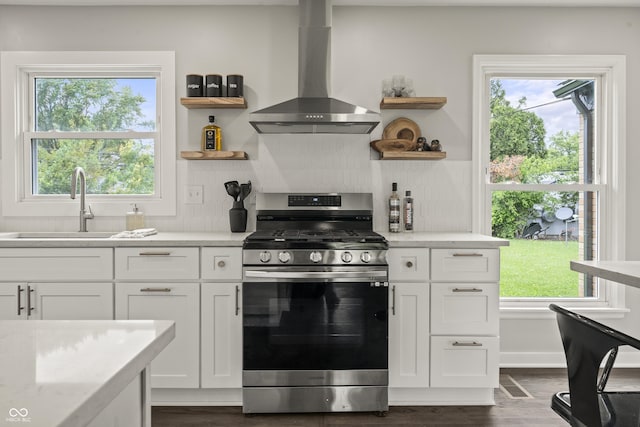 3526 Westfield Dr, Anderson, IN 46011 - kitchen featuring gas range, wall chimney range hood, open shelves, white cabinetry, and dark wood-style flooring