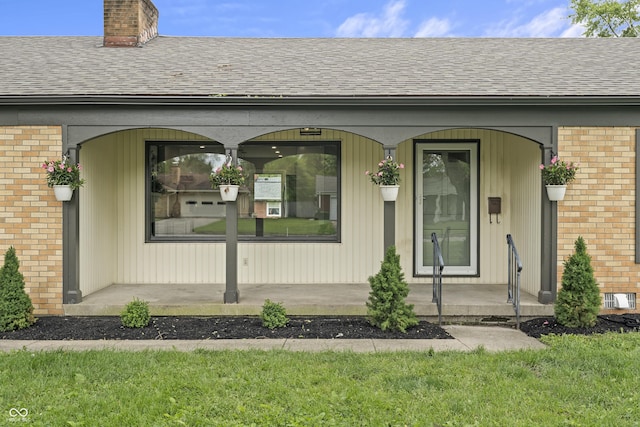3526 Westfield Dr, Anderson, IN 46011 - entrance to property featuring brick siding, a chimney, roof with shingles, and a porch