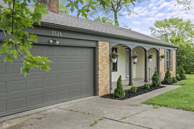 3526 Westfield Dr, Anderson, IN 46011 - garage featuring covered porch and concrete driveway