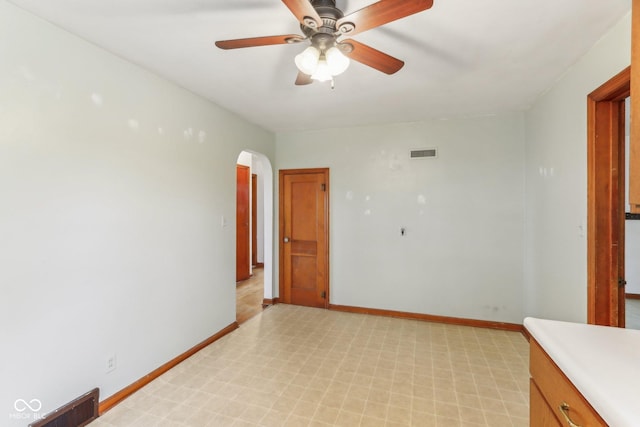 6012 S 625 W, Pendleton, IN 46064 - spare room featuring arched walkways, light flooring, baseboards, and a ceiling fan