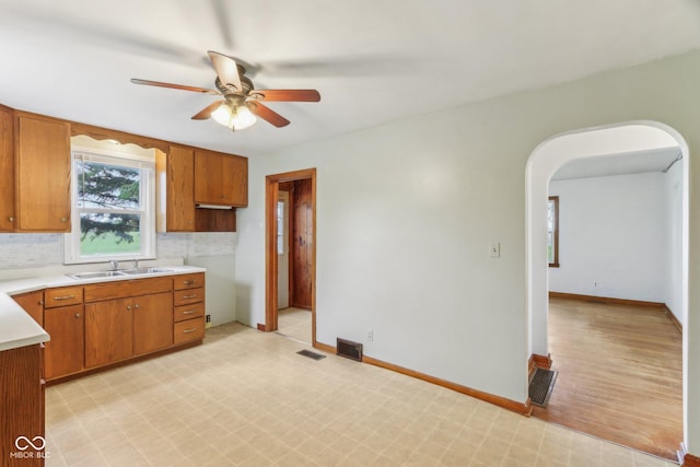6012 S 625 W, Pendleton, IN 46064 - kitchen with a sink, ceiling fan, light countertops, and brown cabinets
