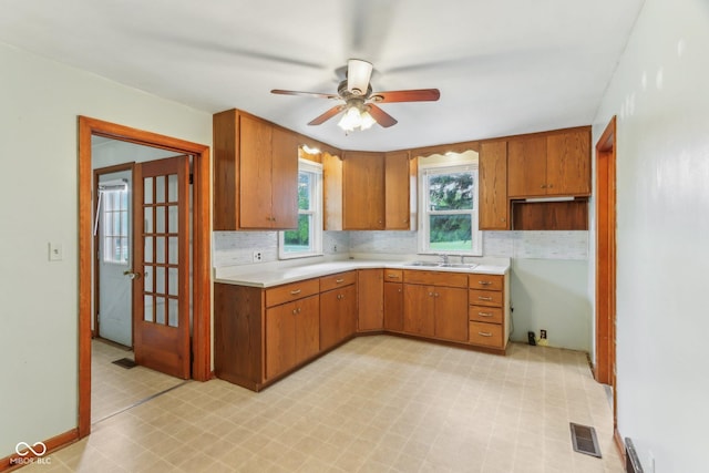 6012 S 625 W, Pendleton, IN 46064 - kitchen featuring light flooring, brown cabinetry, ceiling fan, light countertops, and a sink