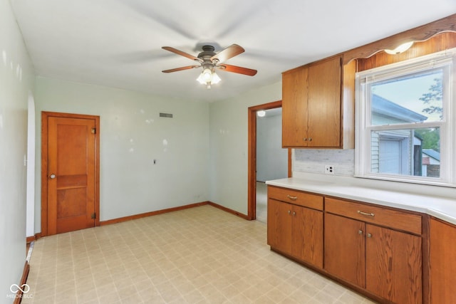 6012 S 625 W, Pendleton, IN 46064 - kitchen featuring light flooring, light countertops, ceiling fan, and brown cabinetry