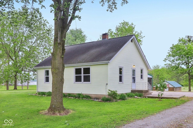 6012 S 625 W, Pendleton, IN 46064 - view of home's exterior featuring a chimney, roof with shingles, and a yard