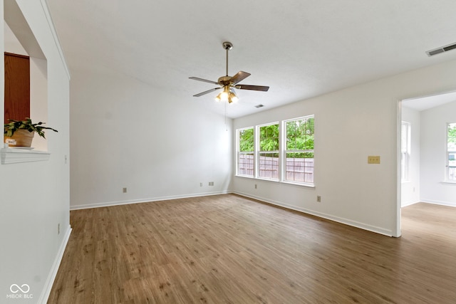 975 Atir Ln, Greenfield, IN 46140 - spare room featuring wood finished floors, a ceiling fan, baseboards, and vaulted ceiling