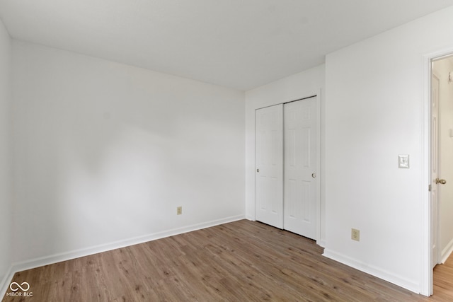 975 Atir Ln, Greenfield, IN 46140 - unfurnished bedroom with wood finished floors, baseboards, and a closet