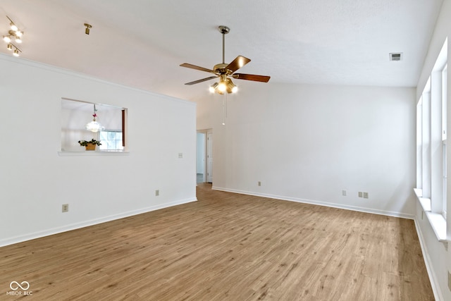 975 Atir Ln, Greenfield, IN 46140 - unfurnished room with wood finished floors, ceiling fan, plenty of natural light, baseboards, and vaulted ceiling