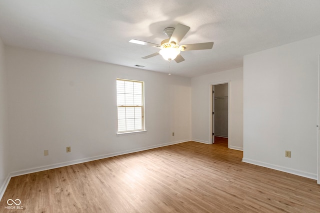 975 Atir Ln, Greenfield, IN 46140 - spare room with light wood-type flooring, ceiling fan, and baseboards