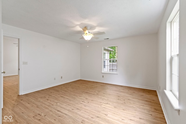 975 Atir Ln, Greenfield, IN 46140 - spare room with light wood-style floors, a ceiling fan, baseboards, and a textured ceiling