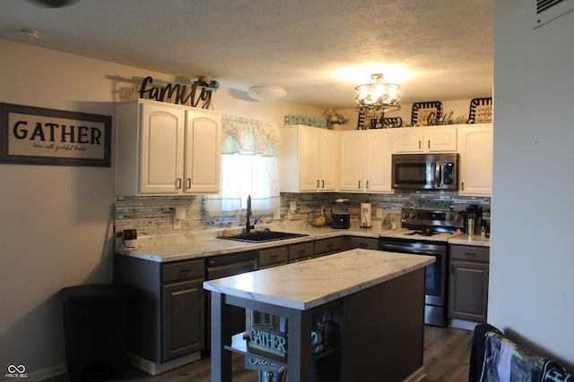 5101 W Bay Rd, Plainfield, IN 46168 - kitchen featuring appliances with stainless steel finishes, a sink, open shelves, backsplash, and a textured ceiling