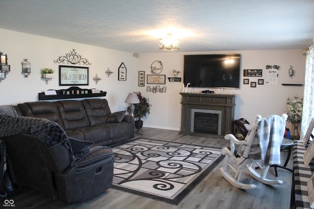 5101 W Bay Rd, Plainfield, IN 46168 - living room with wood finished floors, a fireplace with flush hearth, and baseboards