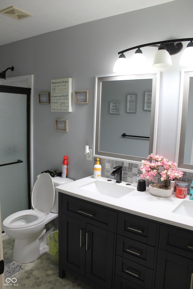 5101 W Bay Rd, Plainfield, IN 46168 - full bath featuring double vanity, a shower stall, decorative backsplash, and toilet