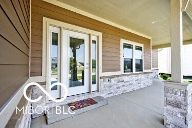 217 N Liberty Blvd, Mooresville, IN 46158 - property entrance with a porch and stone siding