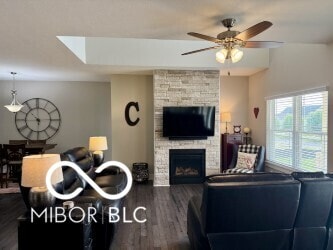 217 N Liberty Blvd, Mooresville, IN 46158 - living area with a stone fireplace, a ceiling fan, dark wood-style floors, and a skylight