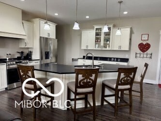 217 N Liberty Blvd, Mooresville, IN 46158 - kitchen with appliances with stainless steel finishes, premium range hood, a sink, dark countertops, and recessed lighting