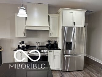 217 N Liberty Blvd, Mooresville, IN 46158 - kitchen featuring stainless steel appliances, custom exhaust hood, dark wood finished floors, white cabinetry, and baseboards
