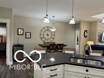 217 N Liberty Blvd, Mooresville, IN 46158 - kitchen featuring a sink, dark countertops, wood finished floors, and white cabinets