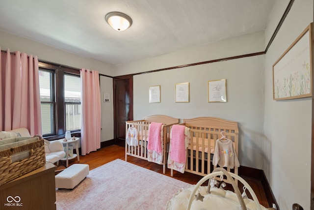 536 S 27th St, Lafayette, IN 47904 - bedroom featuring wood finished floors, a nursery area, and baseboards