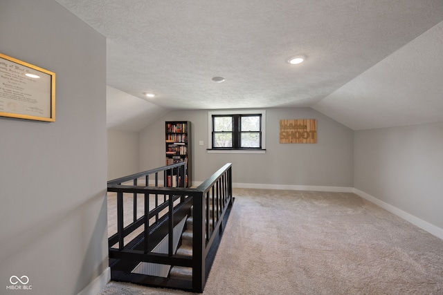 536 S 27th St, Lafayette, IN 47904 - additional living space with a textured ceiling, vaulted ceiling, baseboards, carpet floors, and recessed lighting