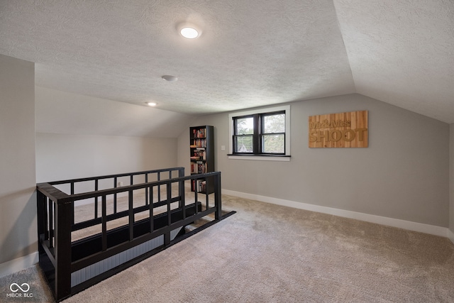 536 S 27th St, Lafayette, IN 47904 - bonus room with lofted ceiling, a textured ceiling, baseboards, and carpet floors