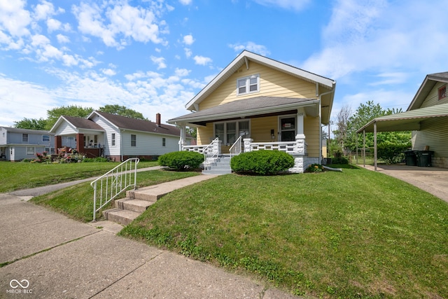536 S 27th St, Lafayette, IN 47904 - view of front of house with covered porch, a front yard, a carport, and driveway