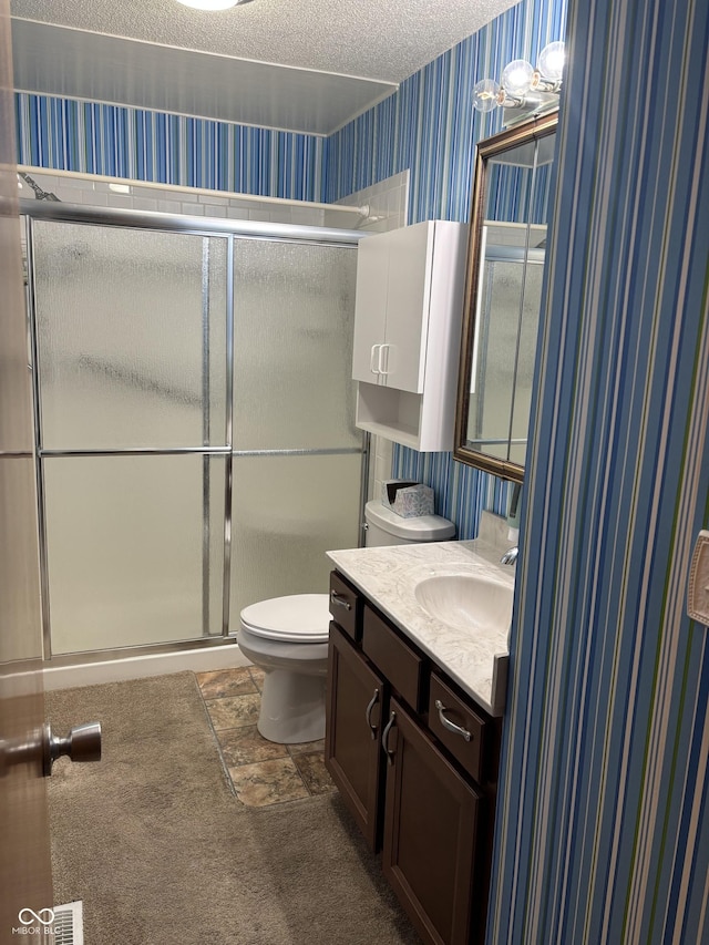 505 N Edward Dr, Greensburg, IN 47240 - bathroom featuring wallpapered walls, toilet, vanity, a shower stall, and a textured ceiling