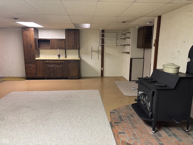505 N Edward Dr, Greensburg, IN 47240 - finished below grade area with a wood stove, a textured wall, and a drop ceiling