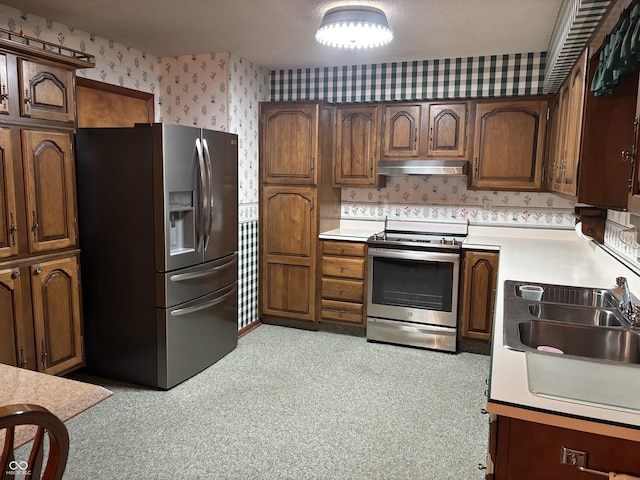 505 N Edward Dr, Greensburg, IN 47240 - kitchen featuring appliances with stainless steel finishes, wallpapered walls, under cabinet range hood, light countertops, and a sink
