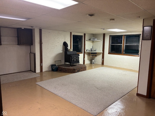505 N Edward Dr, Greensburg, IN 47240 - finished basement with a wood stove, a paneled ceiling, and a textured wall