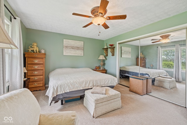 7441 State Road 60 W, Mitchell, IN 47446 - bedroom featuring carpet floors, a closet, a ceiling fan, and a textured ceiling