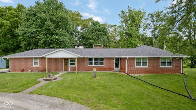 7441 State Road 60 W, Mitchell, IN 47446 - ranch-style house with a front yard, brick siding, entry steps, and roof with shingles