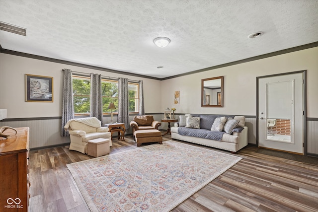 7441 State Road 60 W, Mitchell, IN 47446 - living room with ornamental molding, wainscoting, a textured ceiling, and wood finished floors