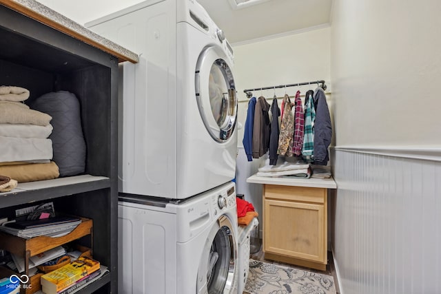 7441 State Road 60 W, Mitchell, IN 47446 - laundry room with stacked washer / dryer, crown molding, and wainscoting