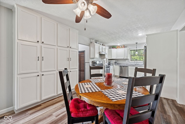 7441 State Road 60 W, Mitchell, IN 47446 - dining space featuring a textured ceiling, ceiling fan, and light wood-type flooring