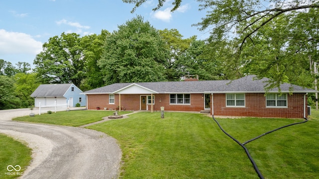 7441 State Road 60 W, Mitchell, IN 47446 - ranch-style house with brick siding, an outbuilding, a front lawn, a detached garage, and a chimney