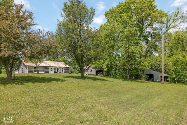 7441 State Road 60 W, Mitchell, IN 47446 - view of green lawn with an outbuilding