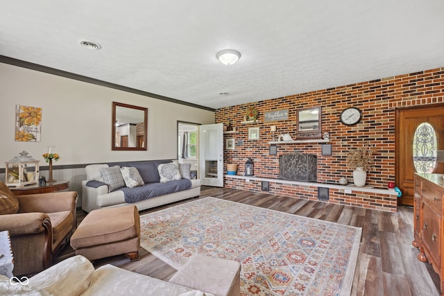 7441 State Road 60 W, Mitchell, IN 47446 - living room with healthy amount of natural light, wood finished floors, ornamental molding, a wainscoted wall, and brick wall