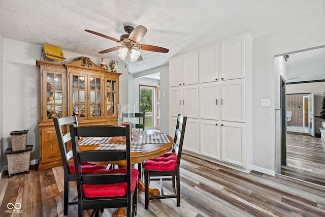 7441 State Road 60 W, Mitchell, IN 47446 - dining area with a textured ceiling, a ceiling fan, and wood finished floors