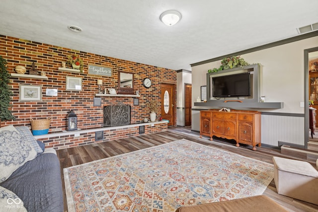 7441 State Road 60 W, Mitchell, IN 47446 - living area with brick wall, wood finished floors, wainscoting, and a brick fireplace