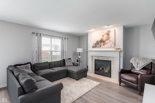 3638 Fieldstone Ln, Plainfield, IN 46168 - living room featuring a tiled fireplace and wood finished floors