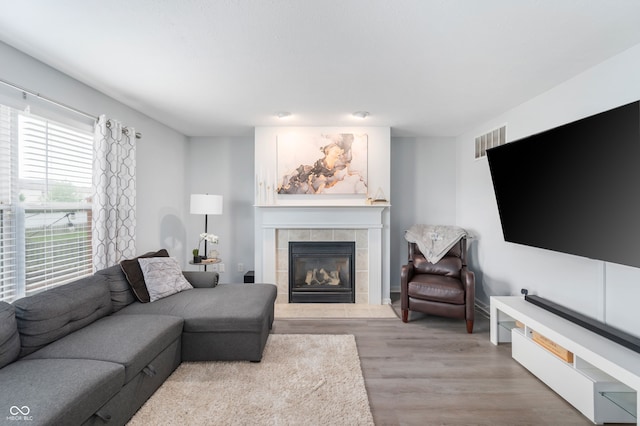 3638 Fieldstone Ln, Plainfield, IN 46168 - living area with a tiled fireplace and light wood finished floors
