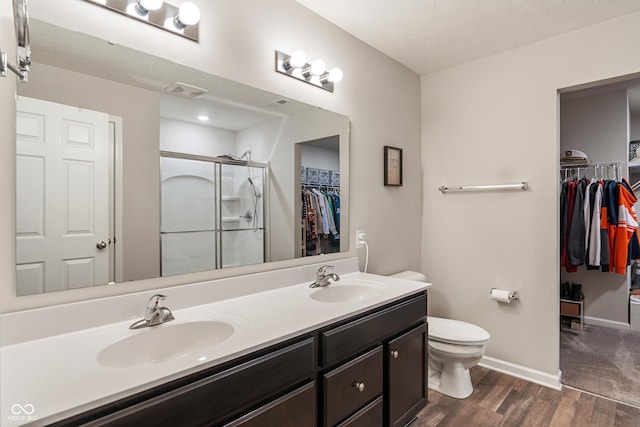918 Cass Dr, Franklin, IN 46131 - full bath featuring a spacious closet, double vanity, wood finished floors, a shower stall, and toilet