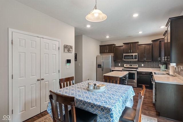 918 Cass Dr, Franklin, IN 46131 - kitchen featuring stainless steel appliances, dark wood-style floors, a sink, dark brown cabinets, and light countertops