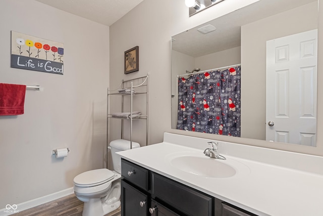 918 Cass Dr, Franklin, IN 46131 - bathroom with wood finished floors, vanity, toilet, baseboards, and a shower with shower curtain